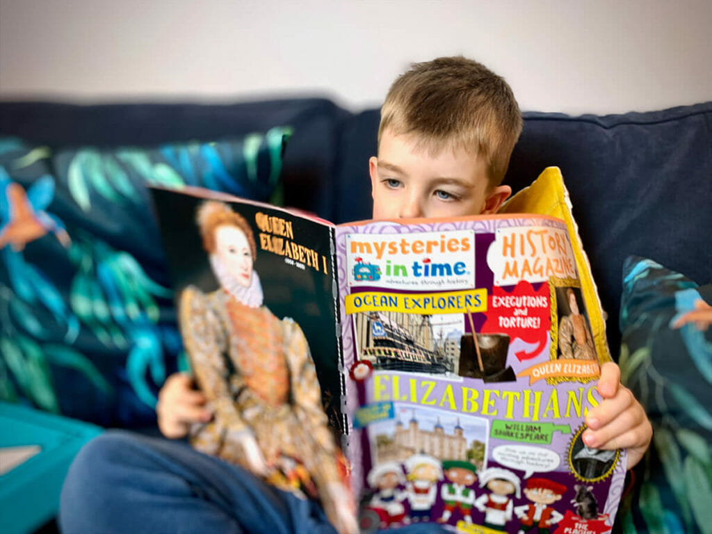 Boy reading Mysteries in Time History Magazine Subscription for Kids